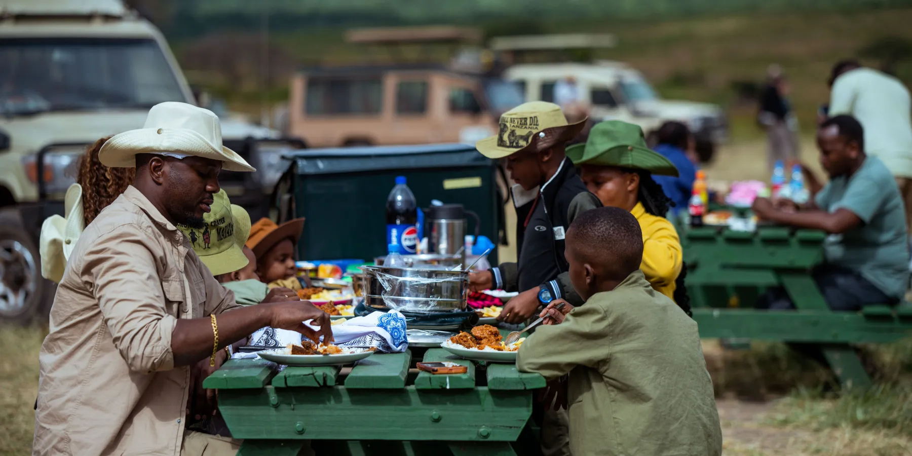 A family sharing a picnic lunch on safari in Tanzania